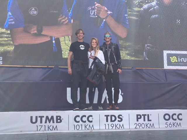 Kelly Wolf (center) with CTS Executive Director Jason Koop (left) on the podium at UTMB's CCC.