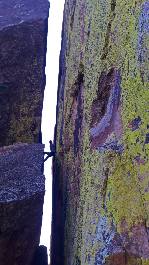 Peter pauses in Green Mountain Pinnacle's distinct chimney on a previous outing (photo: Justin Simoni)