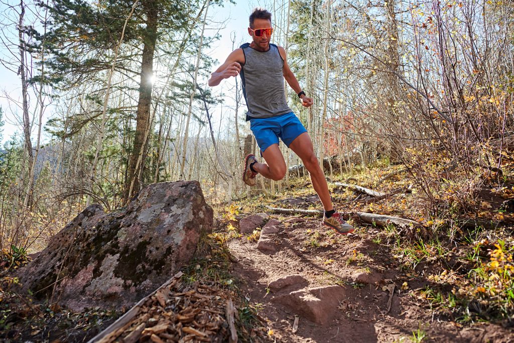 Jason Schlarb running on the trail in new Ultimate Direction apparel.